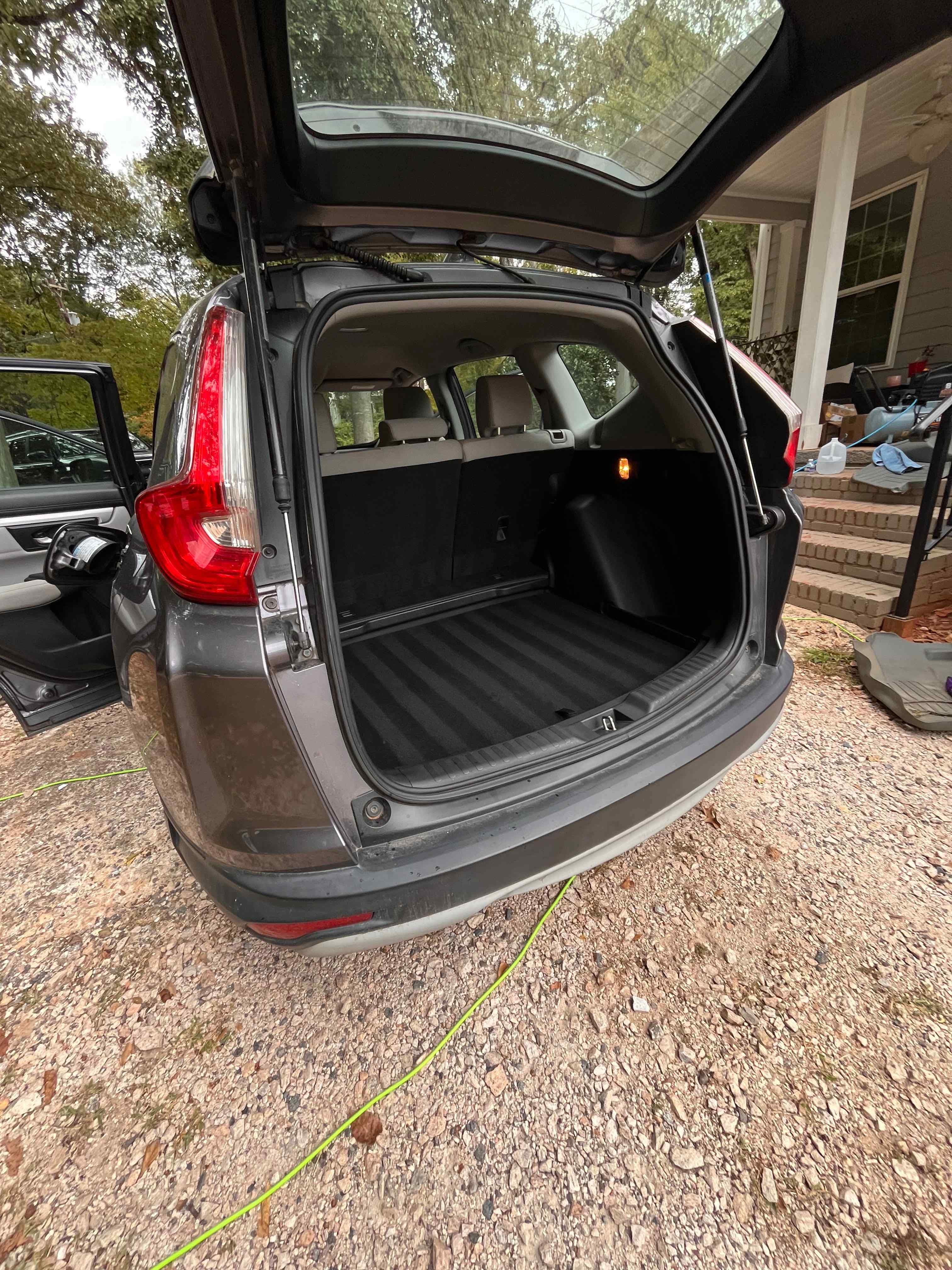 Open vehicle cargo area with a dark cargo mat